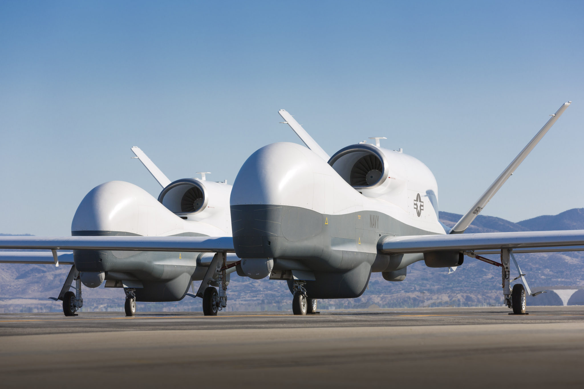 Two Northrop Grumman MQ-4C Triton unmanned aerial vehicles are seen on the tarmac at a Northrop Grumman test facility in Palmdale, Calif. Triton is undergoing flight testing as an unmanned maritime surveillance vehicle