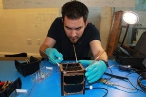 A Spire engineer building a CubeSat