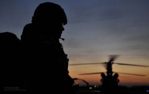 RAF Regiment Soldier Silhouetted in Afghanistan with Chinook Helicopter. Photo: U.K. MoD, available under an Open Government License.