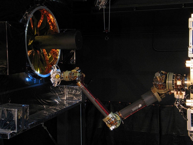 The Front-end Robotics Enabling Near-term Demonstration, or FREND, flight prototype robotic arm performs fully autonomous grapple testing. This testing demonstrates RSGS on-board processing’s ability to track and guide a robotic arm to grapple a launch vehicle adapter ring (left) that is common to many spacecraft designs. Photo: U.S. Naval Research Laboratory (NRL)