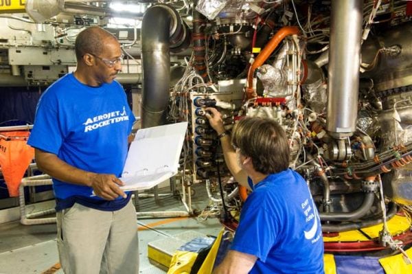 Aerojet Rocketdyne technicians inspect the new controller on the RS-25 development engine