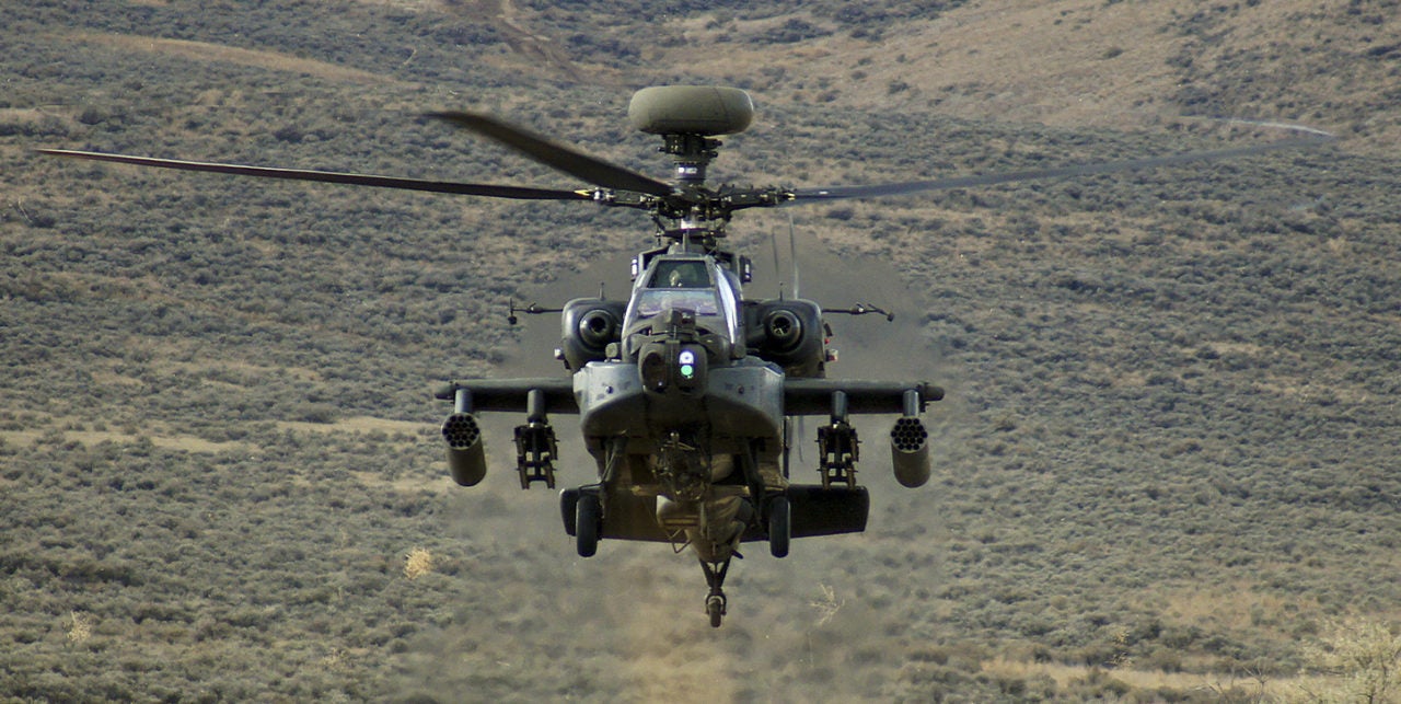 An AH-64 Apache rises from behind a hill during a training exercise at Yakima Training Center. Photo: Wikimedia. 