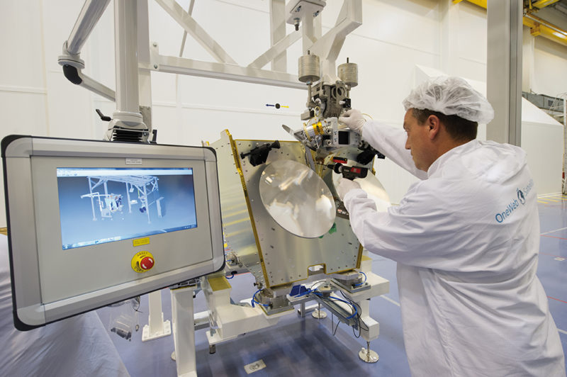 A worker completes tasks manually on the production line at OneWeb Satellite's new facility. Photo: OneWeb. 