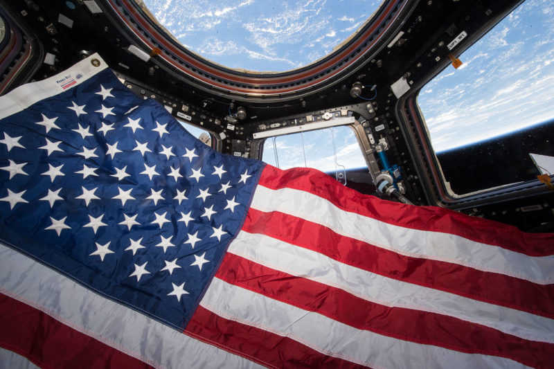 The crew of Expedition 44 observes Flag Day in the U.S. in the ISS' Cupola. Photo: NASA.