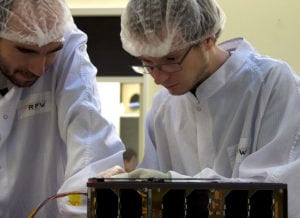 Sylvestre Lacour (left) and Lester David (right) working on PicSat integration. Credit: Observatoire de Paris.