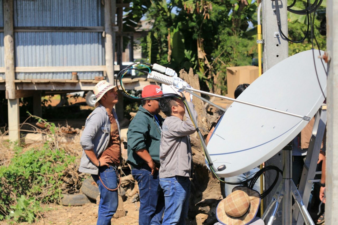 Engineers installing a satellite antenna in a rural location in Thailand (Photo: Business Wire)