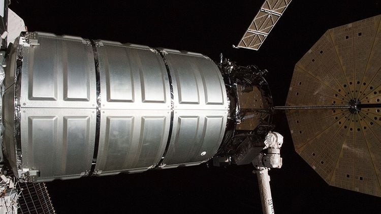The Cygnus resupply ship with its round, brass-colored UltraFlex solar arrays is guided to its port on the Unity module shortly after it was captured with the Canadarm2 robotic arm. Photo: NASA