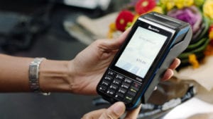 A person using a Verifone card reader. Photo: Business Wire