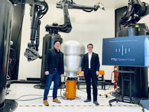 Mu Space CEO and Founder James Yenbamroong and Relativity Space CEO and Founder Tim Ellis stand in front of Relativity's Stargate, the world's largest metal 3D printer. Photo: Business Wire