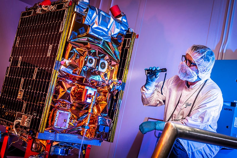 An aerospace engineering performing final checks before the GPIM satellite was shipped to Florida. Photo: Ball Aerospace