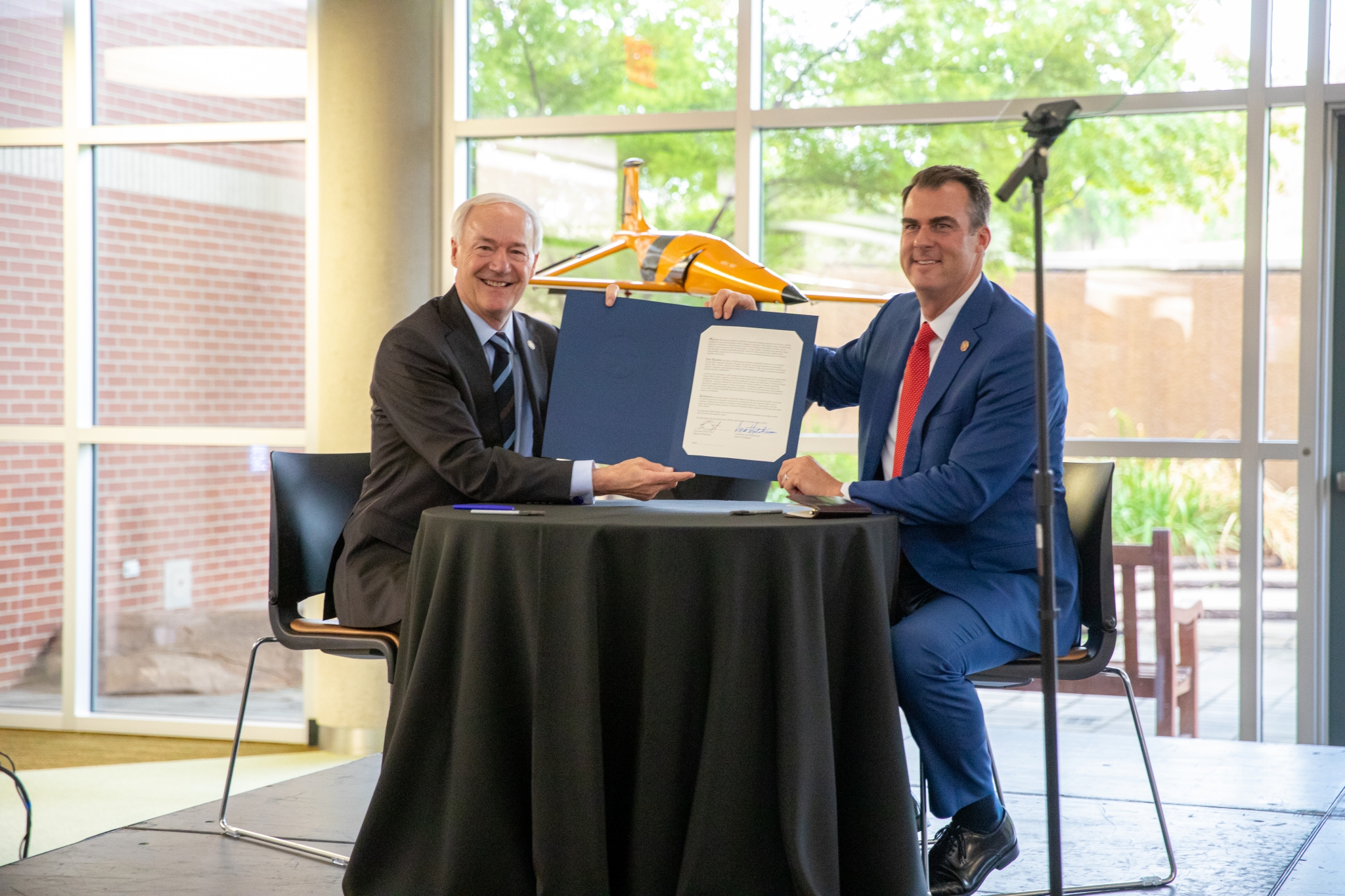 Oklahoma Governor Kevin Stitt, right, and Arkansas Governor Asa Hutchinson, left, announced plans in August 2022 to designate the Oklahoma-Arkansas region as a national hub for advanced mobility
