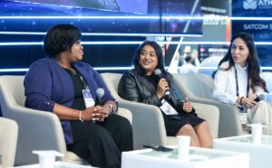 From left: Sharonda Lee-Timberlake of Intelsat, Elizebeth Varghese of Deloitte, and Khayalya Aliyeva of SES, speak on a panel during Cabsat in Dubai in May 2023. Credit: Satcoms Innovation Group